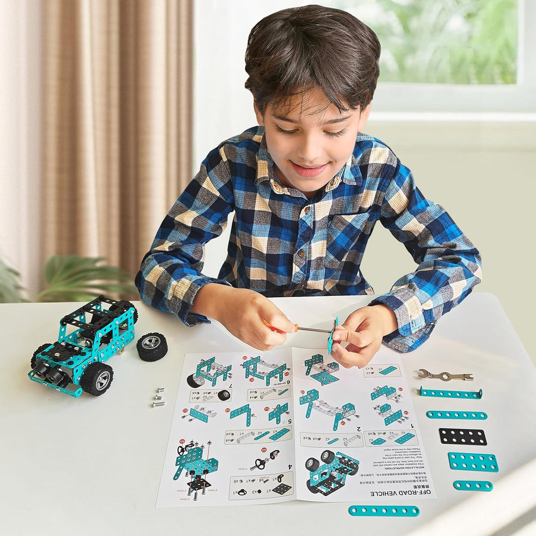 Child assembling a teal off-road vehicle model with instructions and loose metal parts on a table