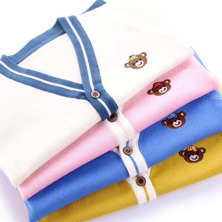Folded teddy bear cardigans in beige white, pink, blue, and yellow with contrasting V-neck trim