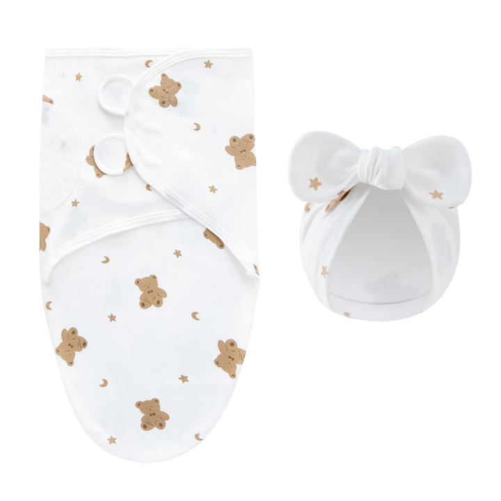White swaddle blanket and matching bow hat with brown teddy bears and small stars