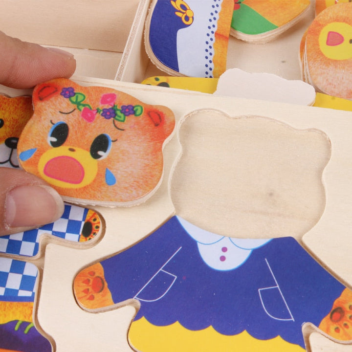 Close-up of a tearful bear head piece being placed on a wooden dress-up puzzle