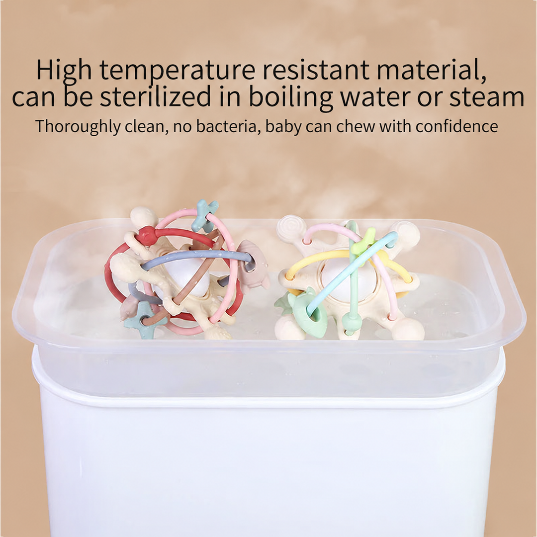Two silicone teething balls in a translucent container with steam rising