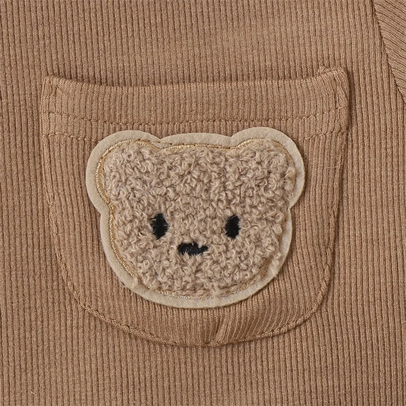 Textured bear-face patch on the brown T-shirt&