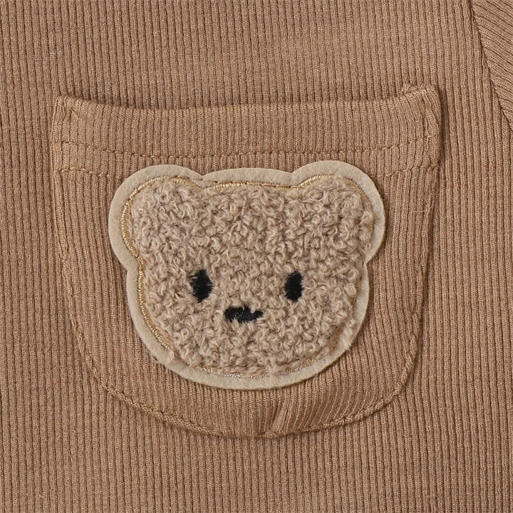 Textured bear-face patch on the brown T-shirt&