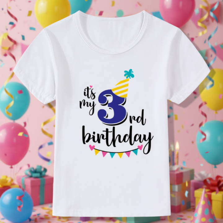 White third-birthday T-shirt with a blue number 3, yellow party hat, and colorful bunting