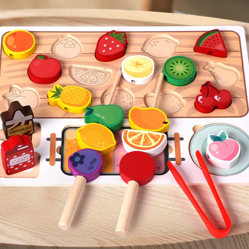 Close view of wooden fruit pieces, two loaded skewers, red tongs and the sorting board