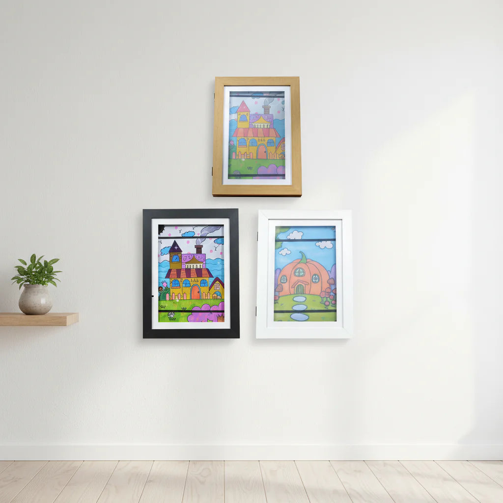 Brown, black, and white art frames displaying colorful drawings on a wall