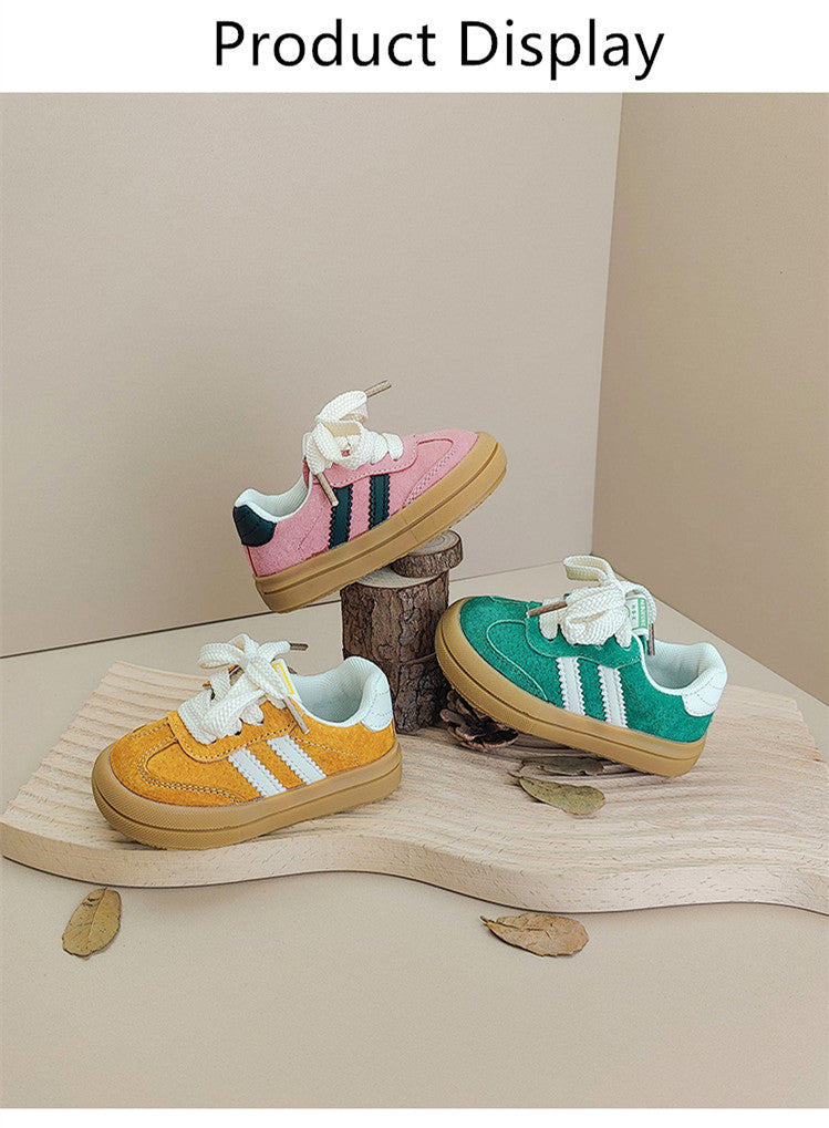 Yellow, pink and green low-top sneakers arranged on a wooden display