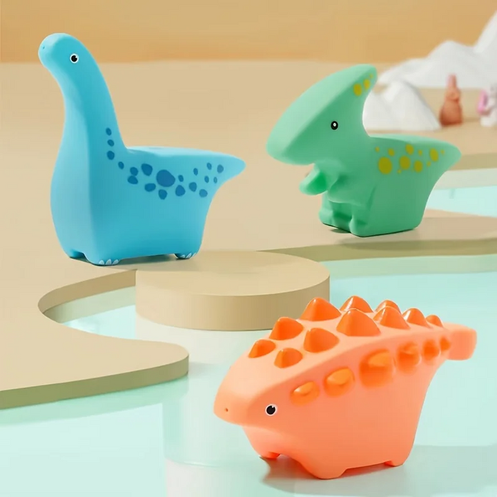Blue, green, and orange dinosaur bath toys in a three-piece set