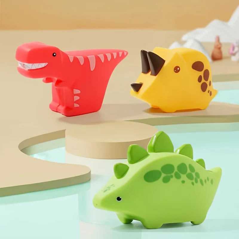 Three-piece dinosaur bath toy set with red, yellow, and green characters