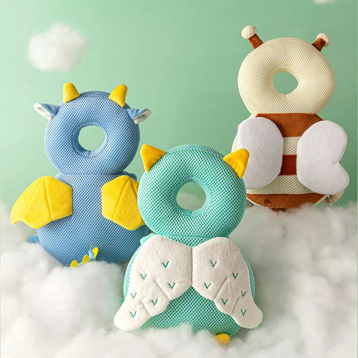 Blue, green, and beige winged head-and-back cushions on a soft white surface