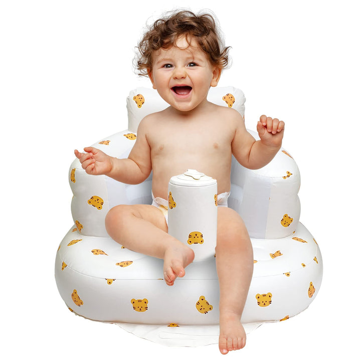 Front view of a child sitting in a white tiger-print inflatable baby seat.