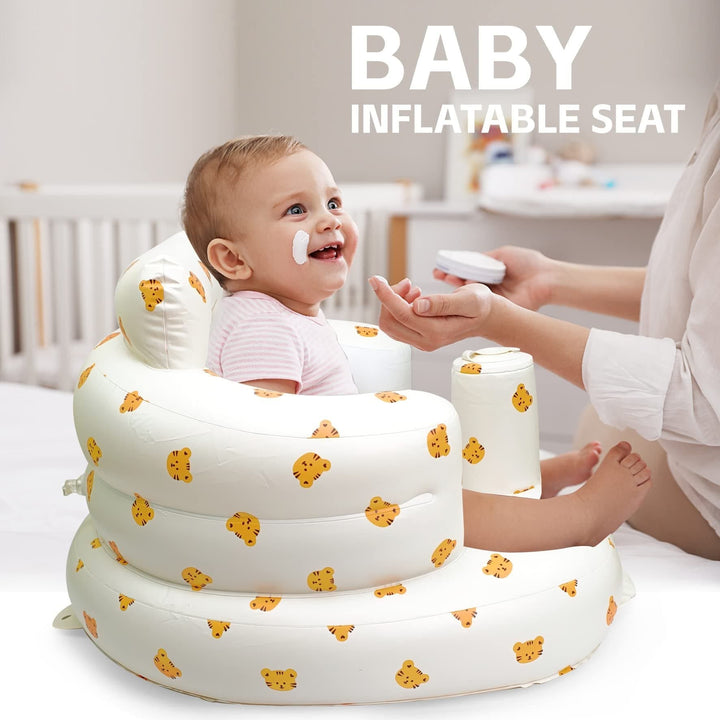 Baby being spoon-fed by an adult while sitting in a tiger-print inflatable seat.