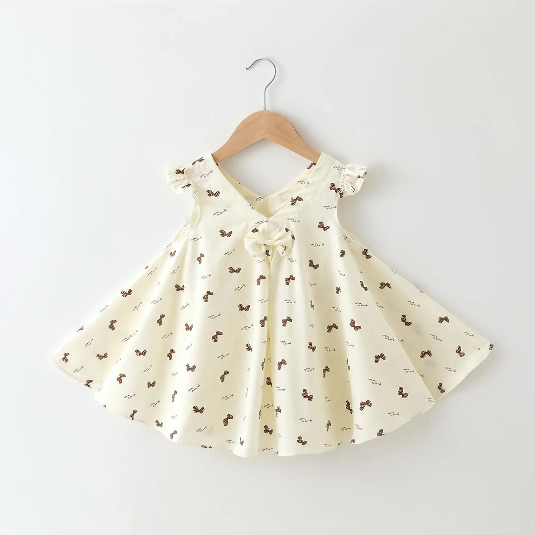 Cream girls' dress with tiny bow print, flutter sleeves, a V-neck, and front bow