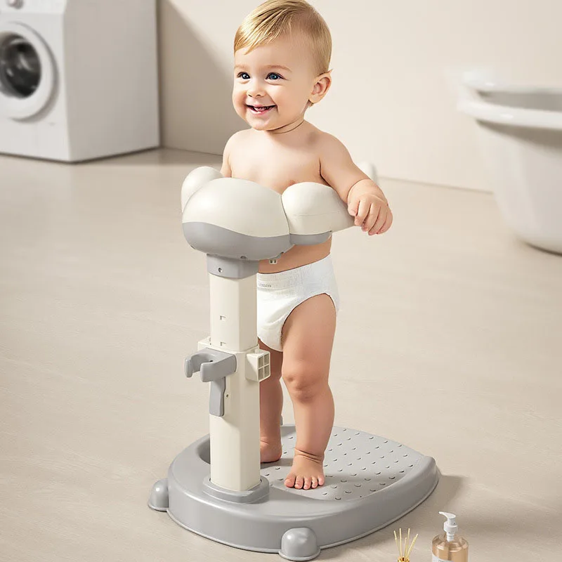 Toddler holding the cloud-shaped ring while standing on the gray shower stand