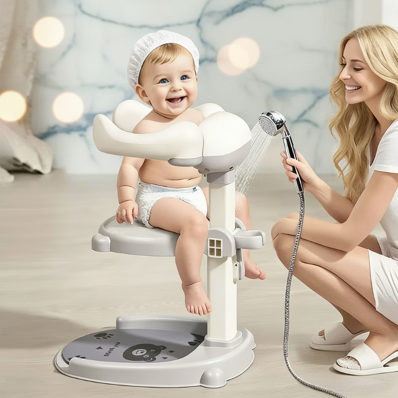 Toddler seated on a gray shower stand while an adult uses a handheld shower