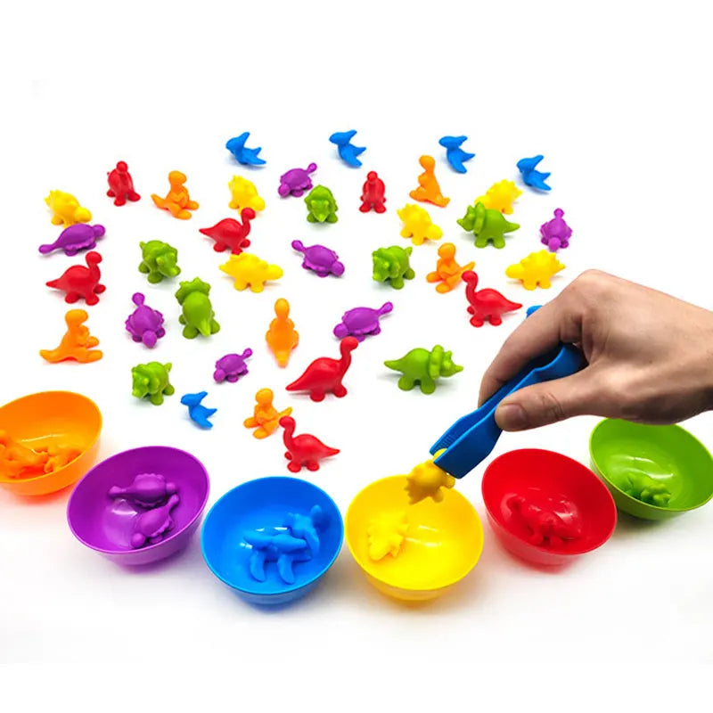 A hand uses blue tongs to place a yellow counting figure into a matching bowl