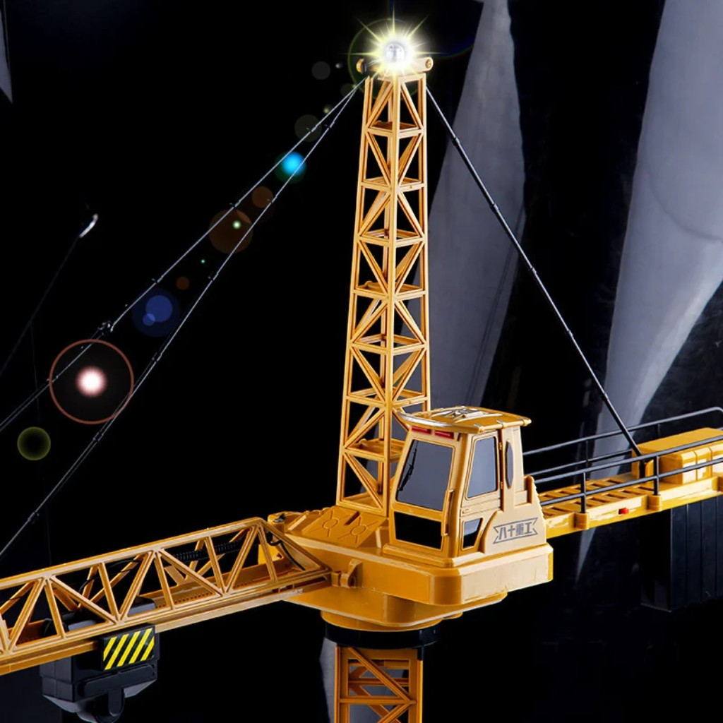 Yellow tower crane with a light at the mast tip and a detailed operator cab.