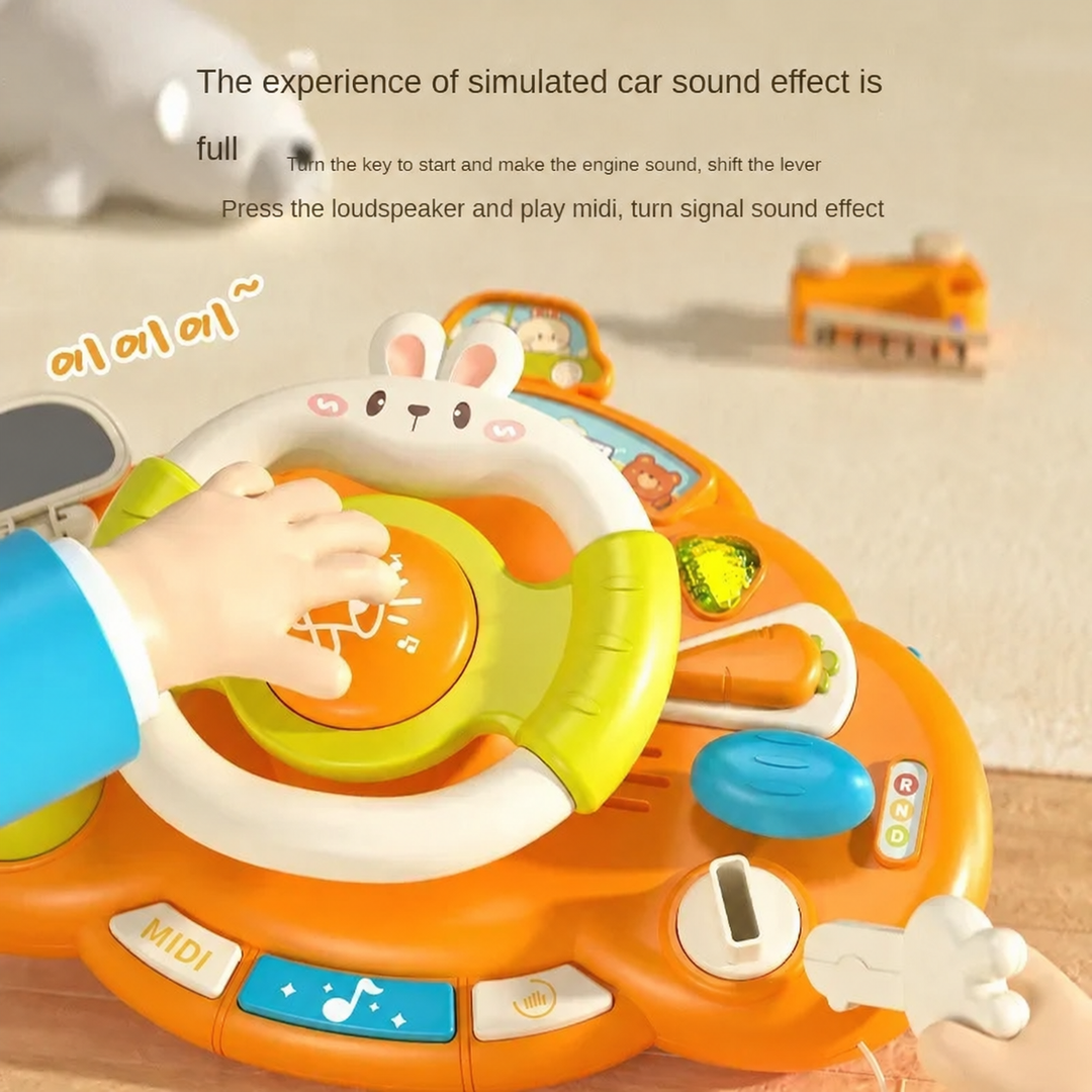 Toy steering wheel with a play key, horn button, and colorful dashboard controls