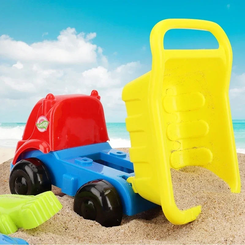 Yellow dump bed shown upright beside a red and blue toy truck on the beach.