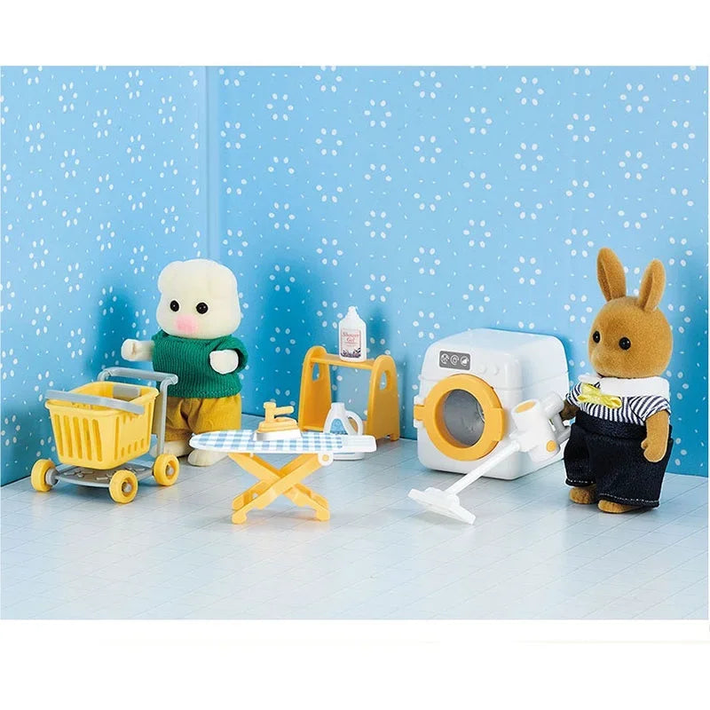 White toy washer and yellow laundry accessories in a blue room scene with two animal figures