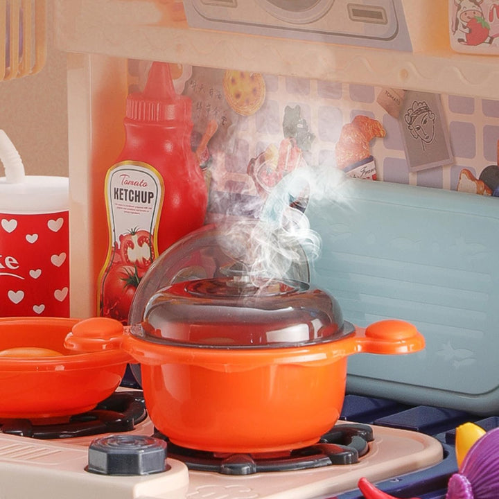 Orange toy pot on a play stovetop with a visible steam effect.