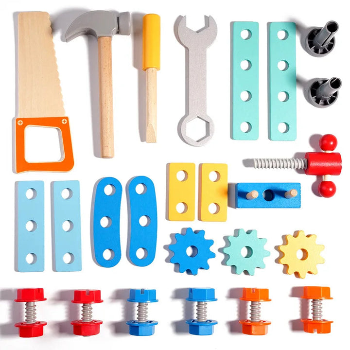Toy saw, hammer, screwdriver, wrench, gears, bolts, and building strips arranged on a white background