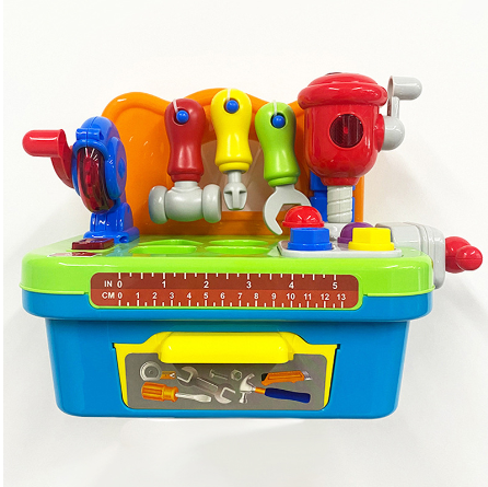 Front view of a toy workbench with a green worktop, hanging tools, and a ruler graphic