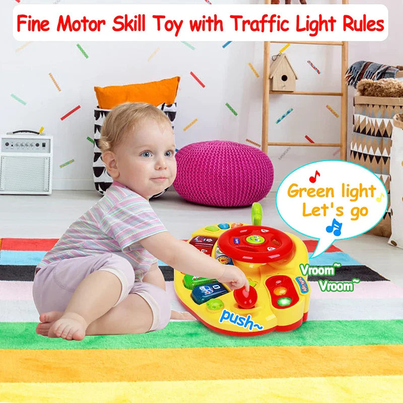 Child sitting beside the yellow driving toy with traffic light buttons and a red steering wheel