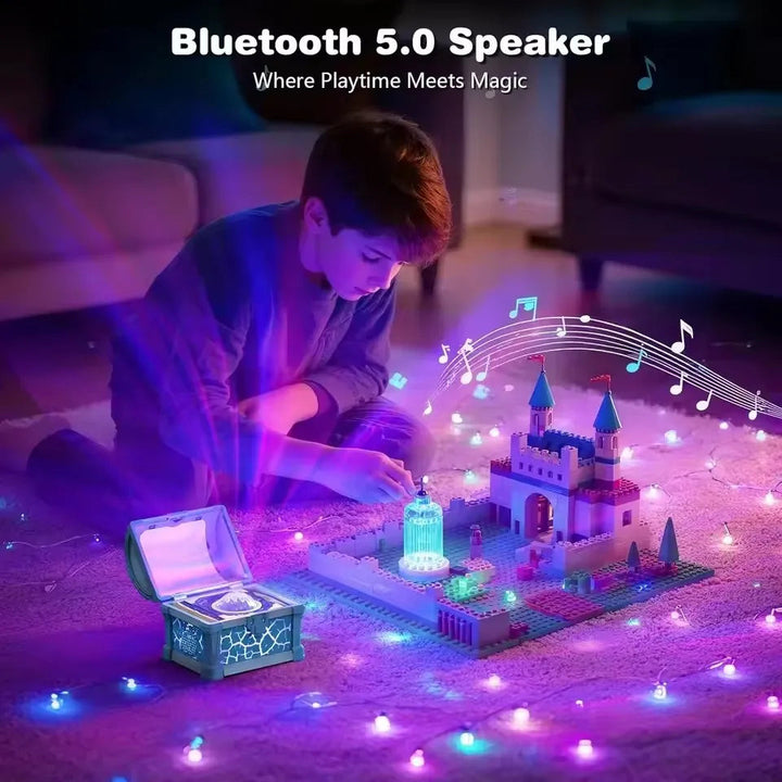 Child playing beside a treasure-chest Bluetooth speaker with colorful lighting