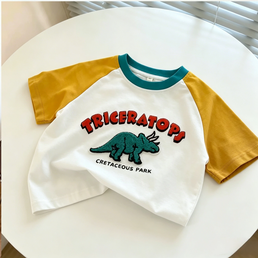 White triceratops T-shirt with yellow raglan sleeves and a teal round neckline