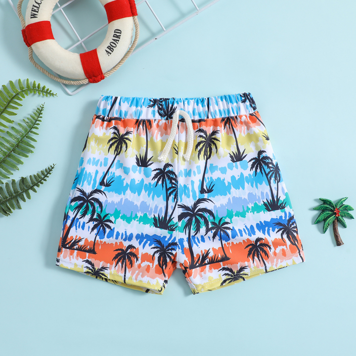 Multicolor swim trunks with tropical palm trees and a white drawstring, laid flat