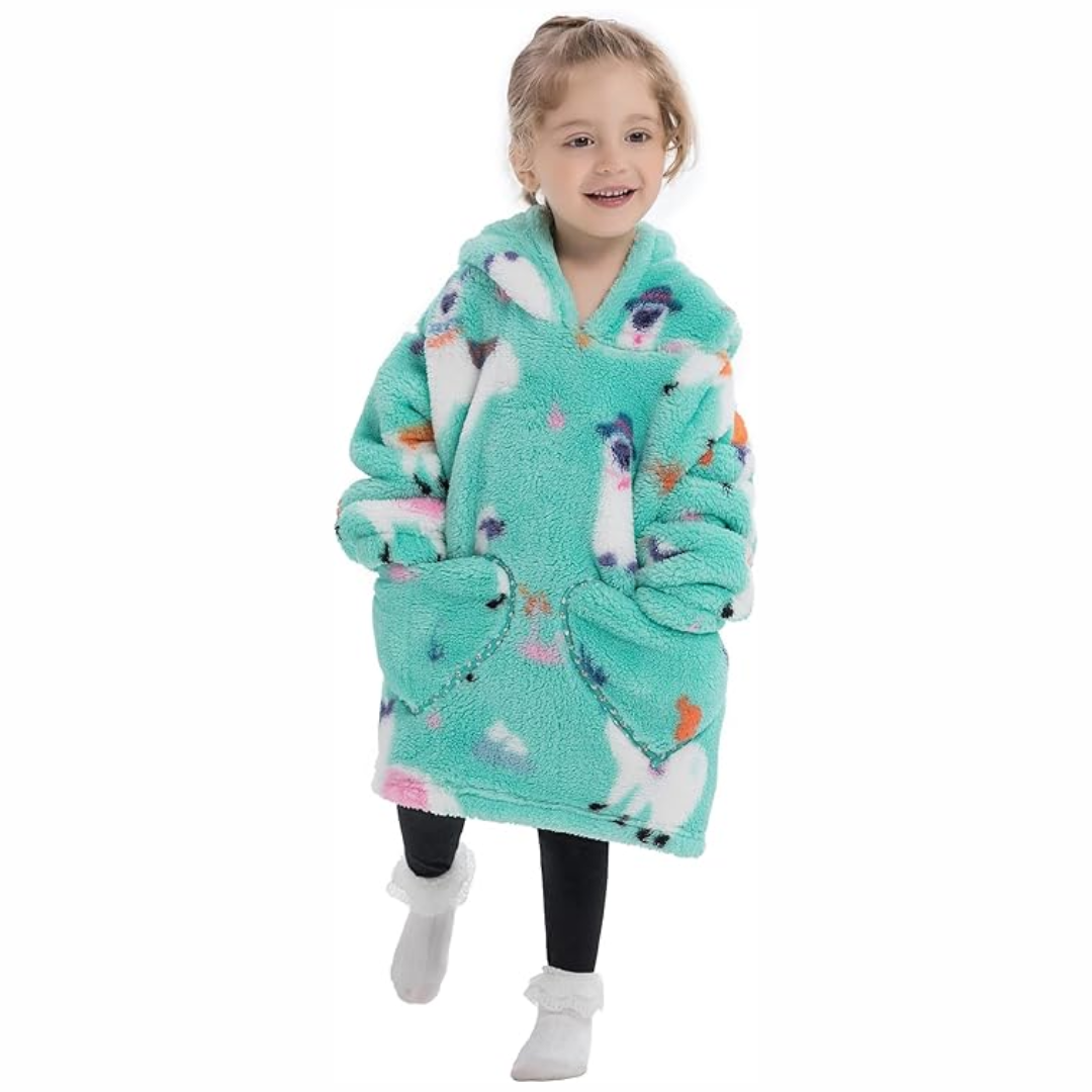 Child wearing a turquoise alpaca-print hooded blanket with two front pockets
