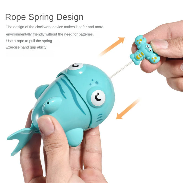 Turquoise bath toy held in two hands with its pull-string handle extended