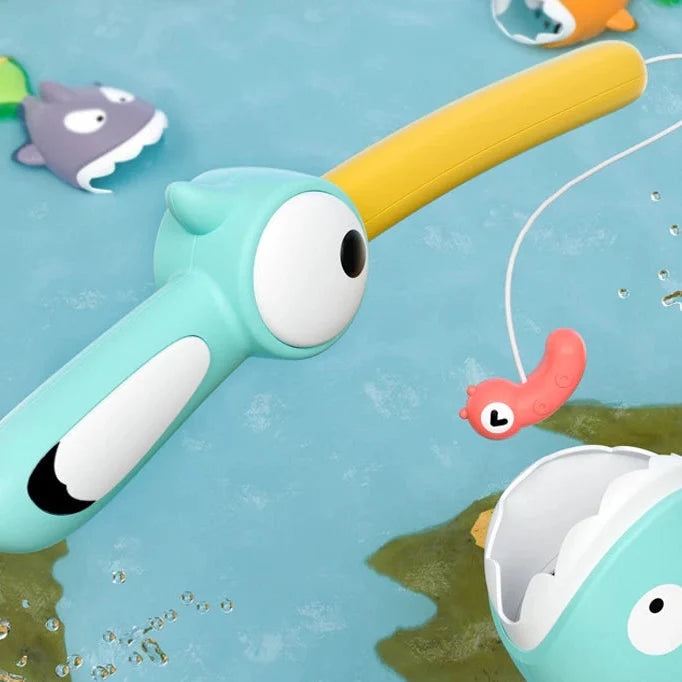 Close-up of the turquoise fishing rod, yellow handle, and pink lure above the water