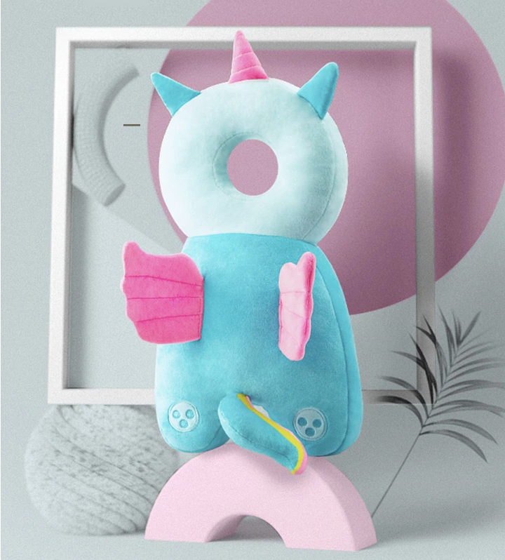Turquoise head-and-back cushion with a pink horn, wings, and a tail