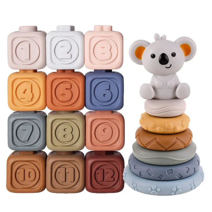 Twelve numbered cubes arranged beside six stacking rings topped with a koala figure