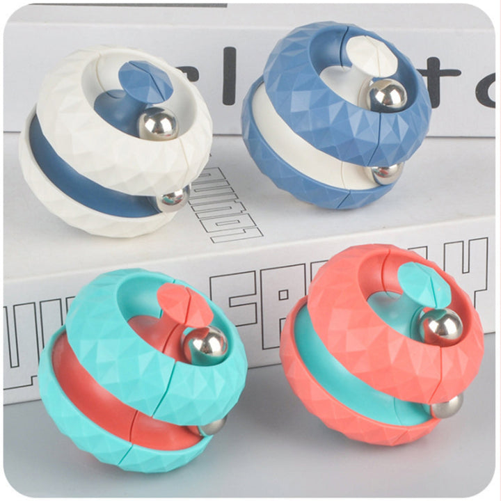 White, blue, turquoise, and pink fidget balls arranged on stacked boxes.