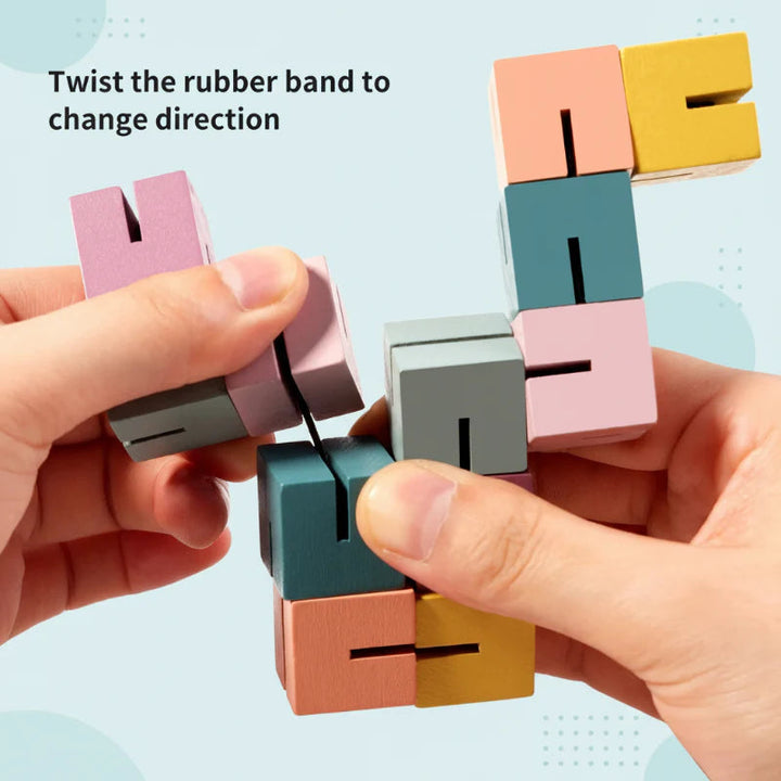 Hands turning the linked wooden blocks to change the puzzle&