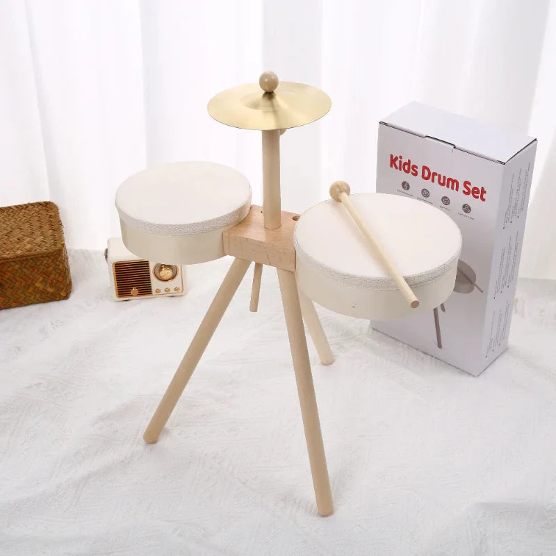 Two-drum wooden set with a metal cymbal, drumsticks, and packaging