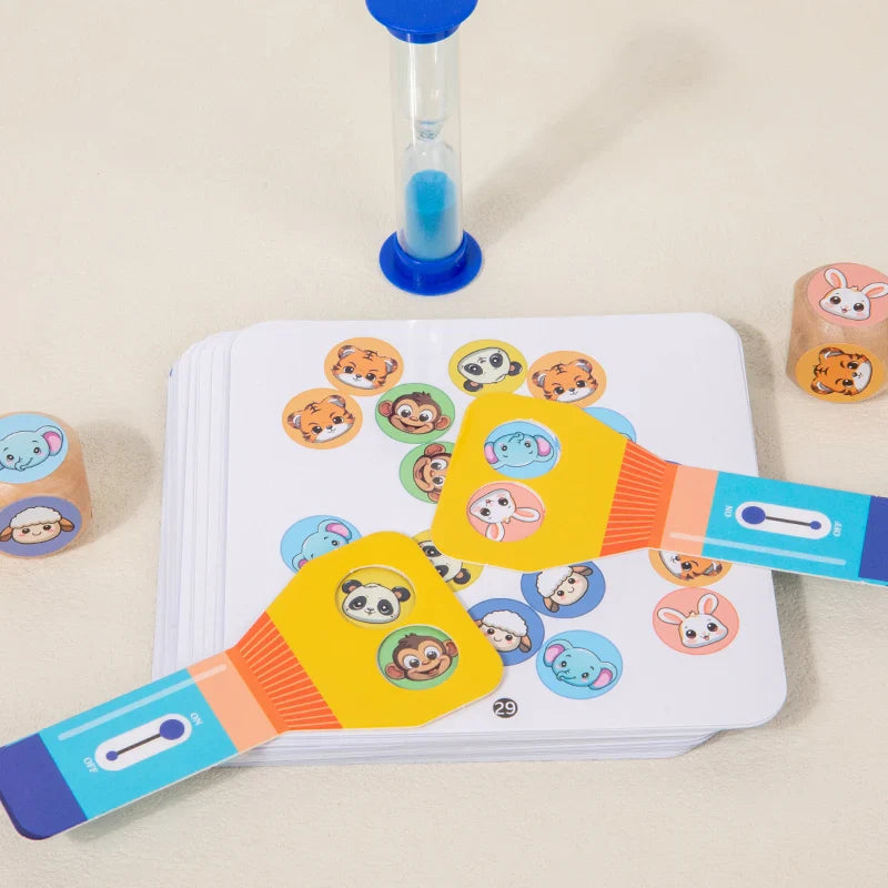Two flashlight-shaped paddles overlapping on an animal-picture card beside dice and an hourglass