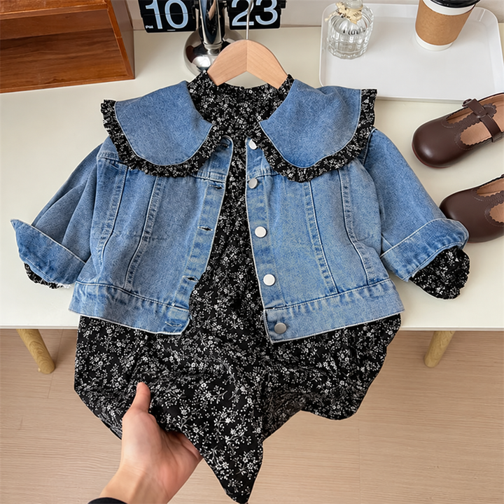 Two-piece outfit with a blue denim jacket and black floral dress on a hanger
