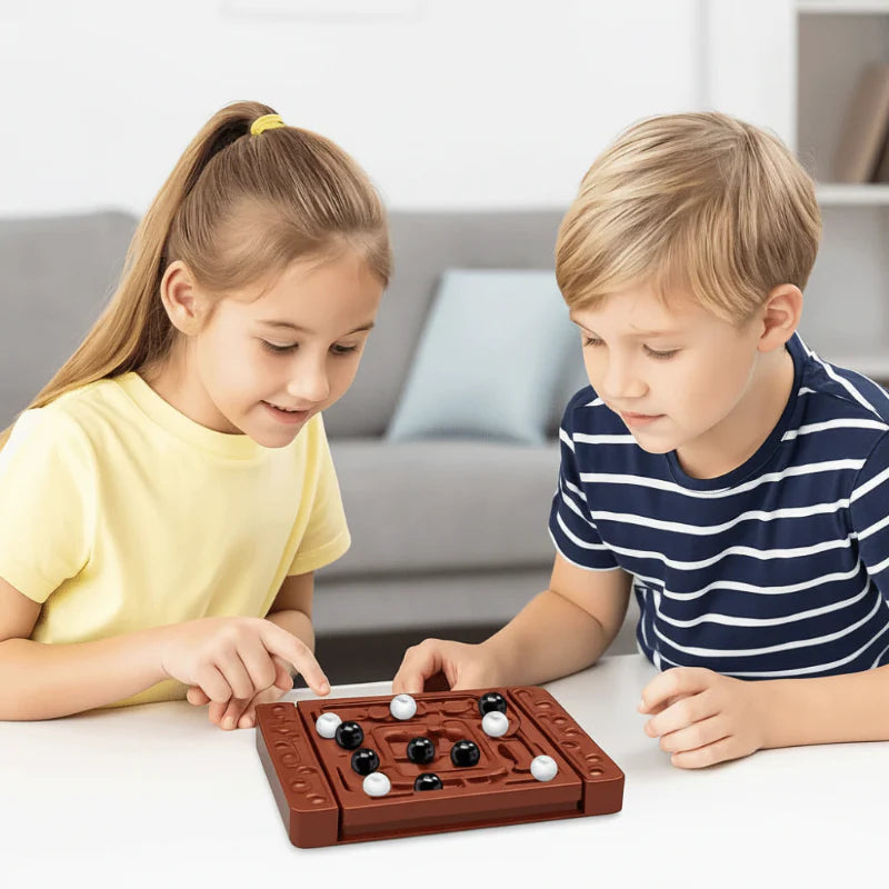 Two children considering their next move on a board with black and white playing pieces