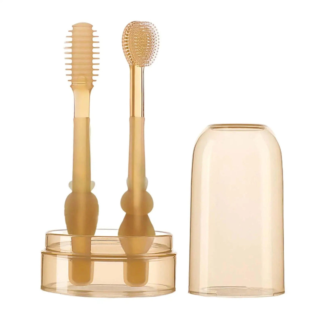Two silicone baby toothbrushes in a storage cup with the matching cover beside them