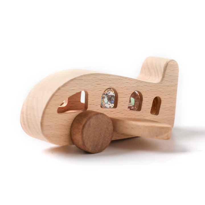 Side view of the Type 2 natural wood airplane with cutout windows and wooden wheels