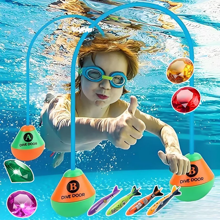 Child underwater beside blue diving loops, colorful play gems and shark-shaped pool toys