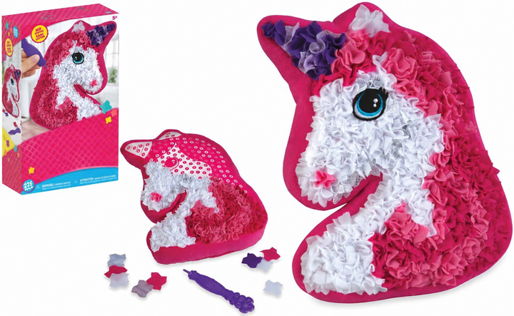 Unicorn pillow craft kit with its box, fabric pieces, purple tool, and completed design.
