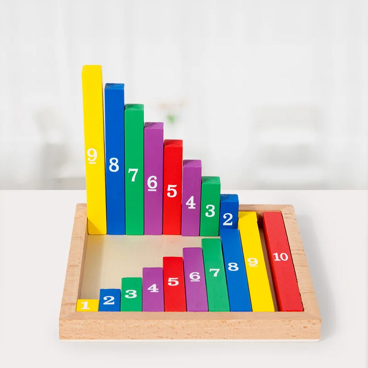 Colorful number rods standing by height behind matching pieces in a wooden tray