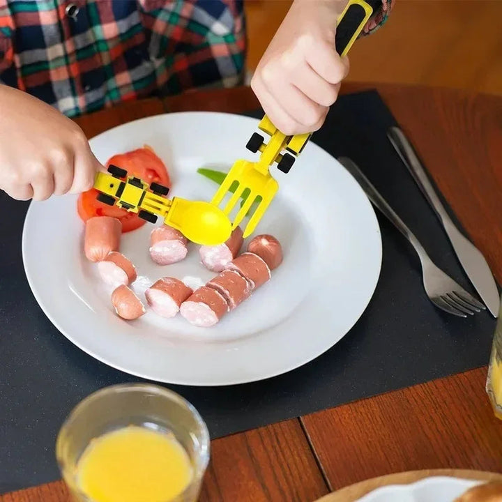 Hands using yellow vehicle-shaped cutlery with sliced food on a white plate.