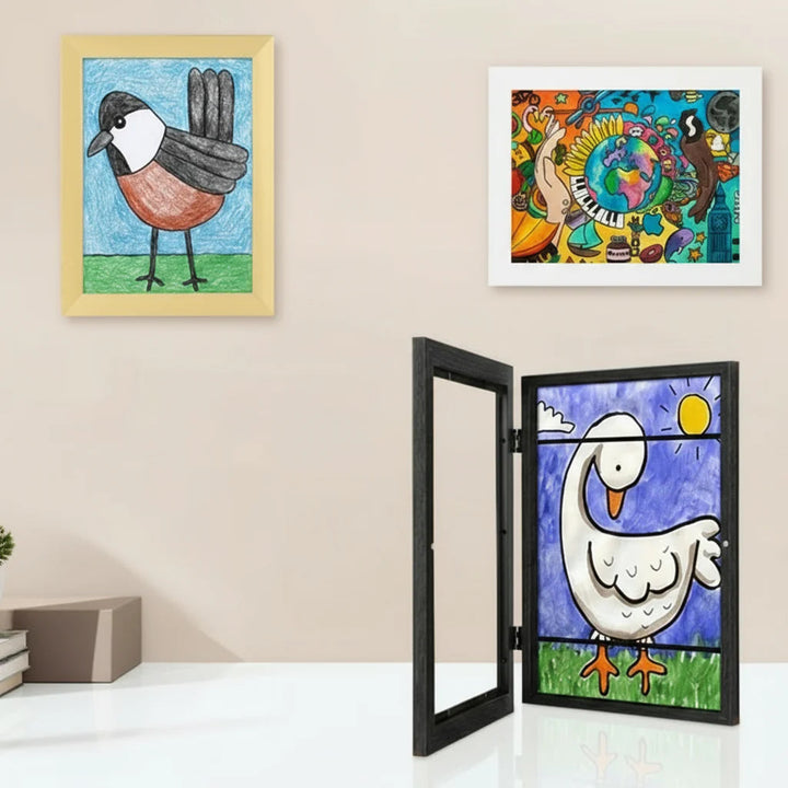 Framed wall art with a front-opening black art frame on the table