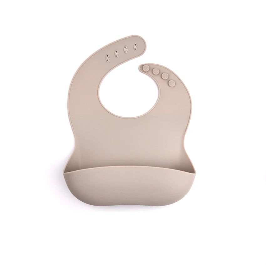 Warm gray silicone bib with a curved food pocket and adjustable neck snaps.